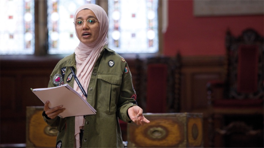 A student sharing her ideas during a debate