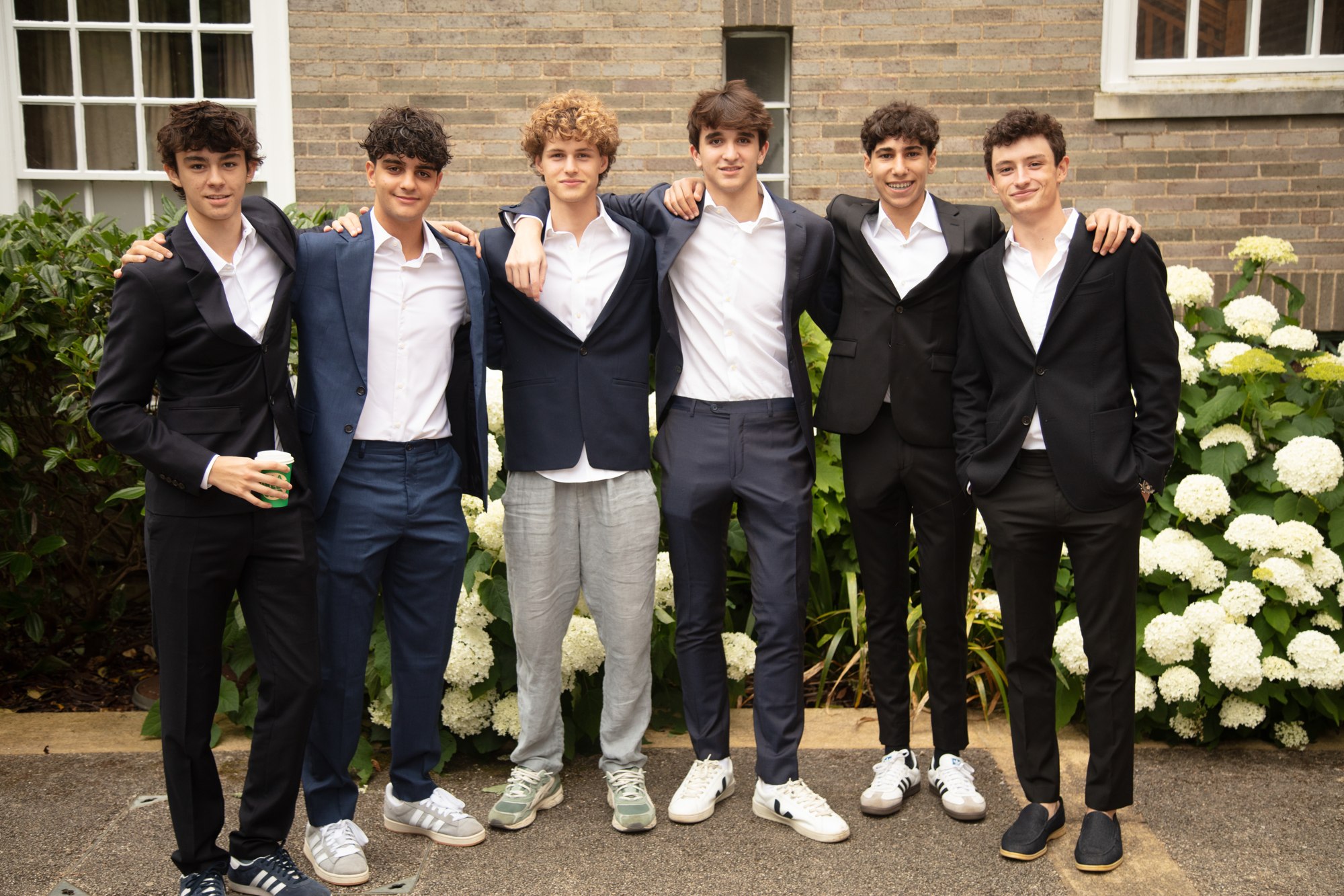 Students facing the camera in a college courtyard